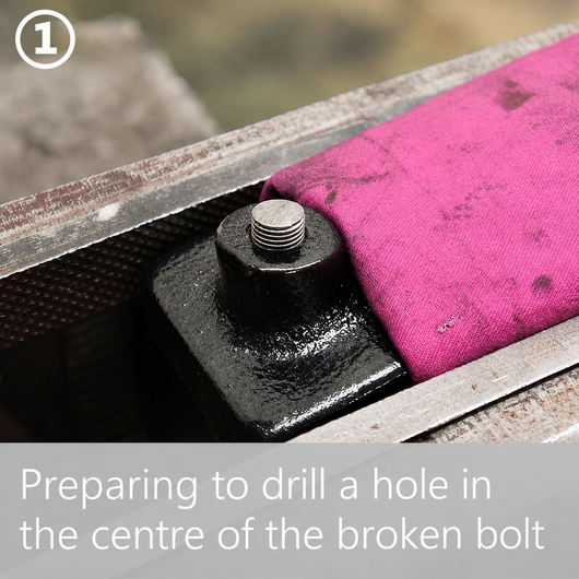 Step 1: a bolt snapped off flush in a black metal bracket, ready to be centre-drilled